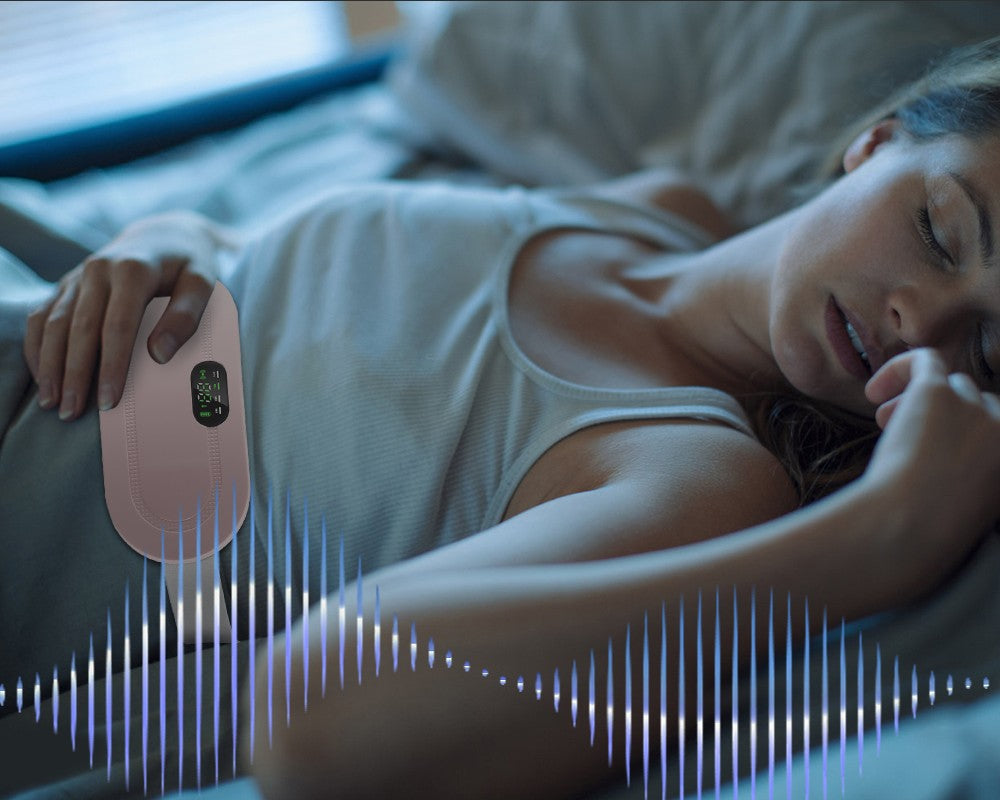 Woman using electric menstrual warm belt for pain relief and comfort while relaxing in bed.